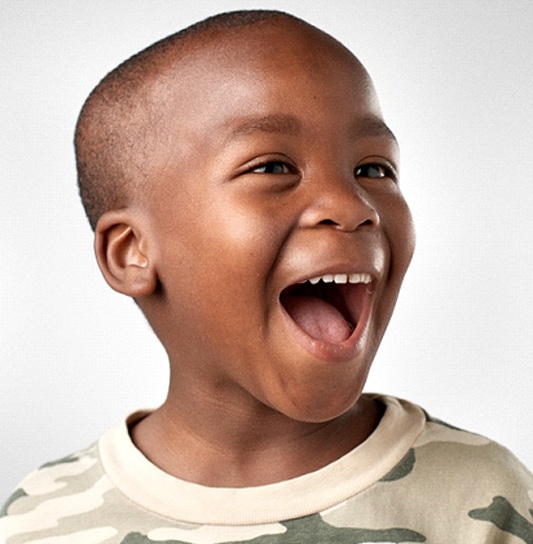 Young boy smiling after fluoride treatment in Cumming, GA
