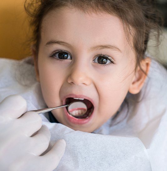 Child receiving dental treatment
