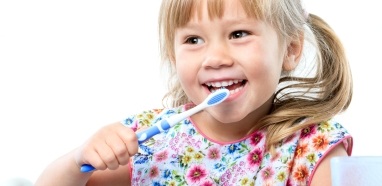 Child brushing teeth at preventive dentistry appointment