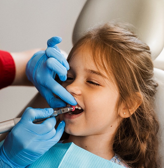 Little girl having her teeth cleaned