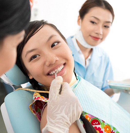 A young female having her teeth checked and cleaned while at the dentist’s office