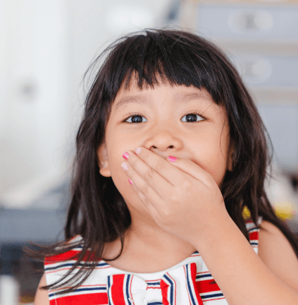 Child with lost filling covering mouth