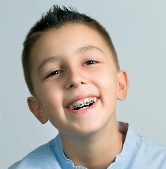 Young boy smiling after tooth extraction