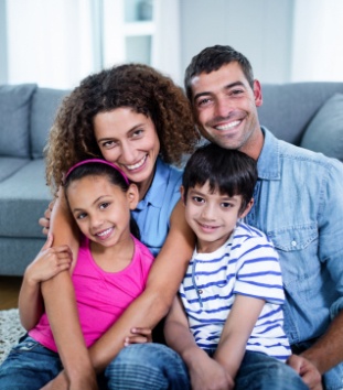 Family of four sharing healthy smiles