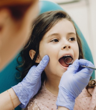 Young girl receiving dental checkup