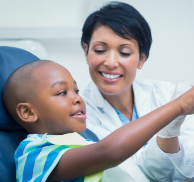 Child talking to dentist in dental chair