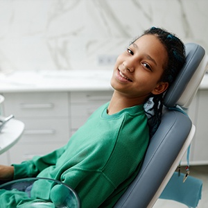 Dentist smiling while sitting in treatment chair