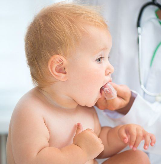 Dentist checking an infant's gums