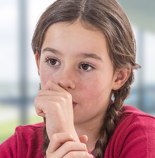 Young girl sucking her thumb