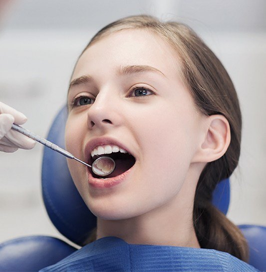 Child receiving dental checkup