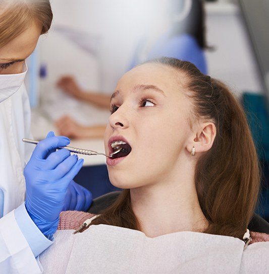 Teen girl receiving oral cancer screenings