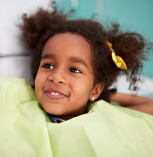 Young girl smiling after fluoride treatment