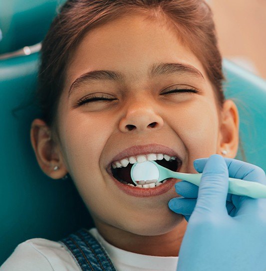 Young girl receiving tooth-colored filling