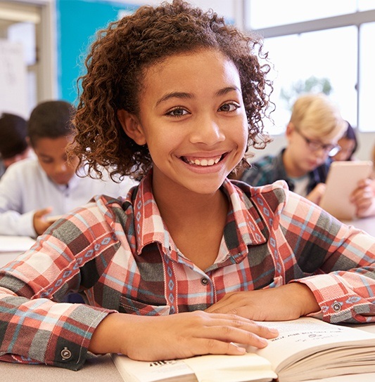 Young girl in classroom smiling