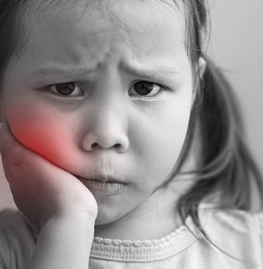 Little girl holding her cheek