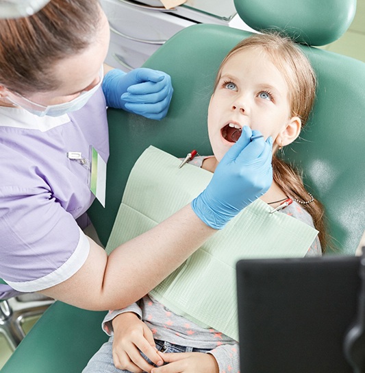 Dentist checking patient’s mouth
