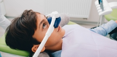 Child in dental chair receiving nitrous oxide dental sedation