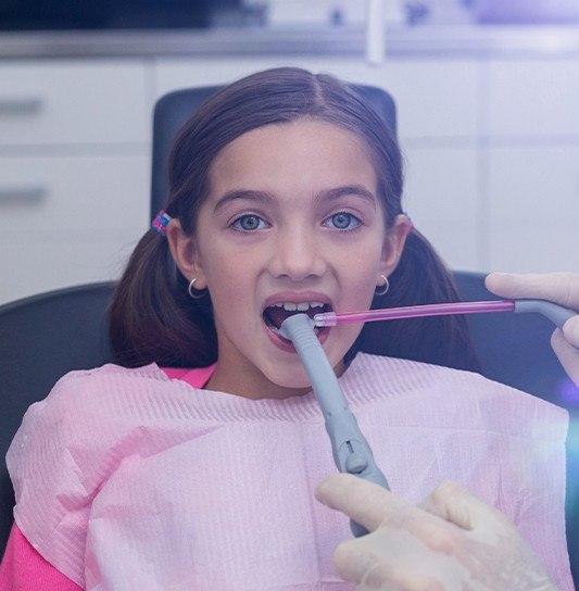 Dentist capturing intraoral images of child's smile