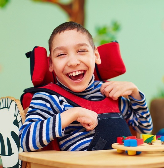 Laughing child in wheelchair