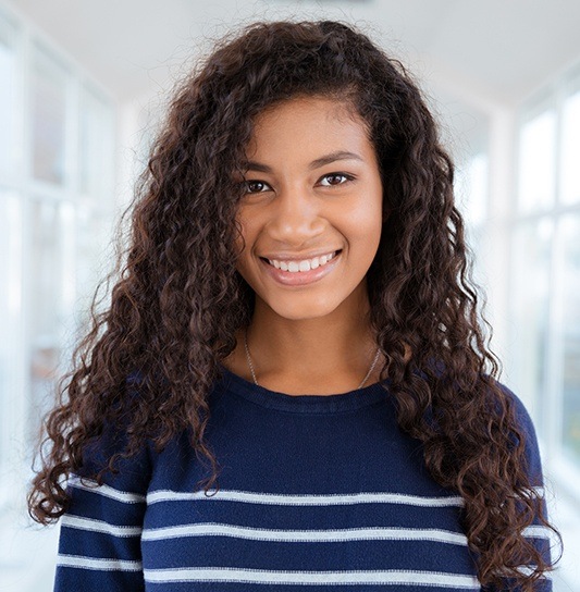 Teen girl smiling after wisdom tooth extraction