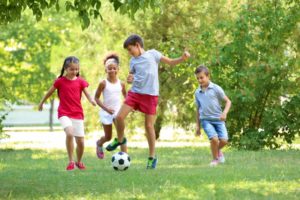 Children playing outside with a soccer ball