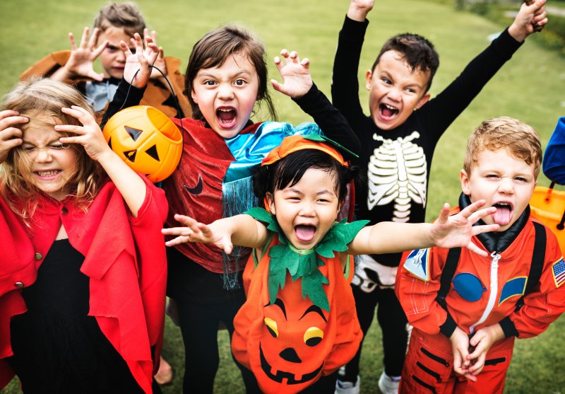 A group of kids in their spooky Halloween costumes with good oral health