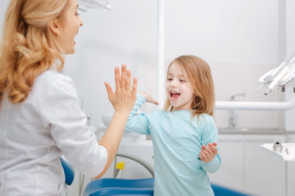 Girl high-fiving dentist
