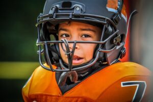 Child in football uniform.